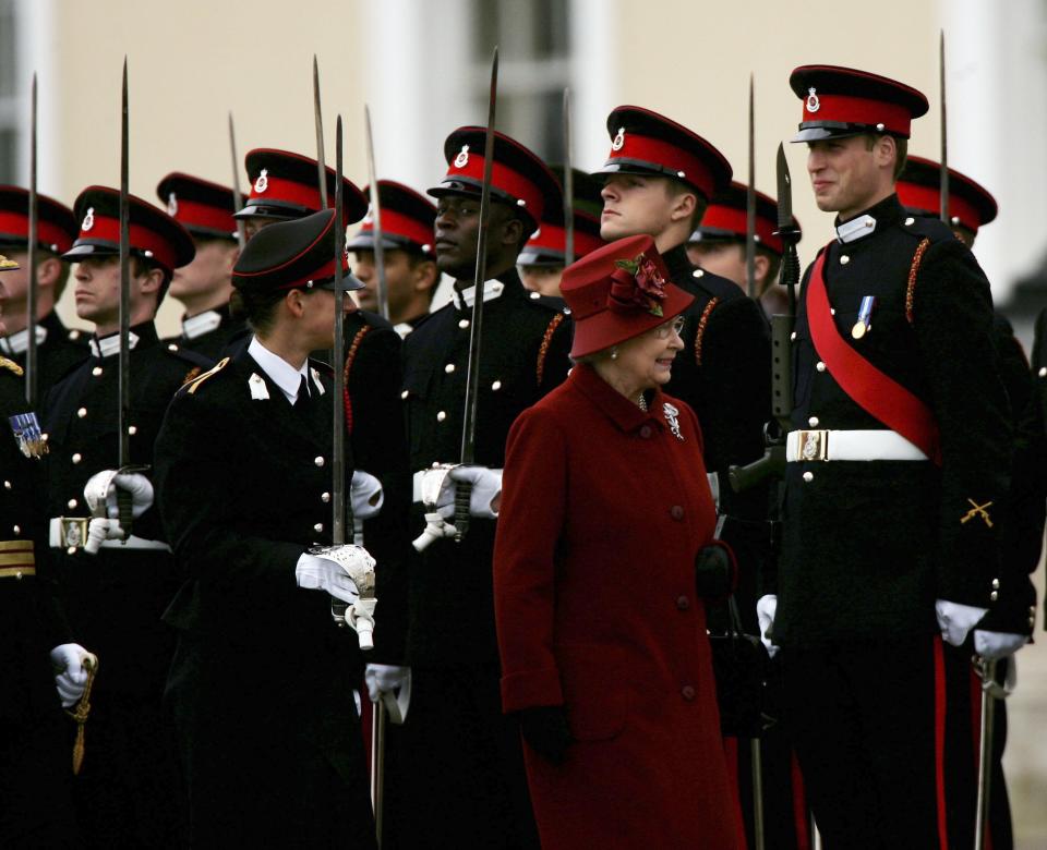 SANDHURST, ENGLAND - DECEMBER 15:  HRH Prince William (R with red sash) is inspected by his grandmother HM Queen Elizabeth II as he takes part in The Sovereigns Parade at The Royal Military Academy Sandhurst on December 15, 2006 in Sandhurst, England.There were 446 Officer Cadets in the parade of which 227 were passing out and 14 different countries armed forces were represented.  (Photo by Julian Herbert/Getty Images)
