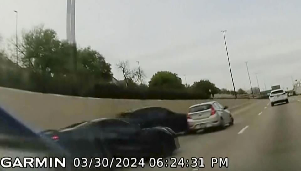 In this screen grab taken from dash camera video provided by Bill Nabors, two speeding sports cars, left and second from left, cause a chain-reaction crash on the North Central Expressway, in Dallas, Saturday, March 30, 2024. Dallas police said Wednesday, April 10, that Kansas City Chiefs' wide receiver Rashee Rice faces charges including aggravated assault after he and another speeding driver of a sports car caused a chain-reaction crash on a Dallas highway. (Bill Nabors via AP)