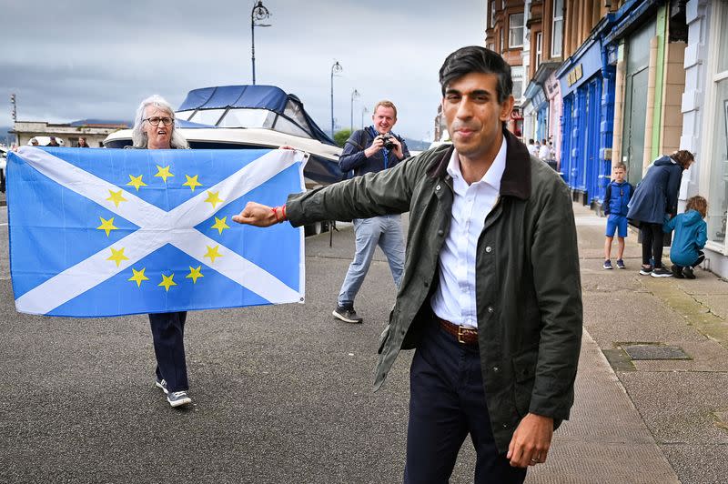 FILE PHOTO: Nationalist demonstrators welcome Britain's Chancellor of the Exchequer Rishi Sunak in Rothesay