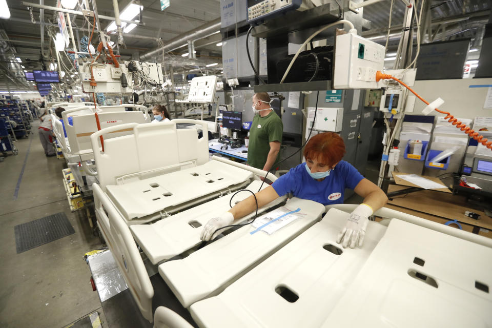 A worker assembles a hospital bed, at the Linet factory in Slany, Czech Republic, Monday, Oct. 19, 2020. A Czech hospital bed maker with a full order book received one more order that was impossible to turn down. The company was approached by Prime Minister Andrej Babis to deliver beds for a military field hospital for 500 COVID-19 patients, to be built this week in Prague. (AP Photo/Petr David Josek)