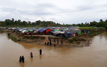 Rohingya refugees cross a stream to reach their temporary shelters at No Man’s Land between Bangladesh-Myanmar border, at Cox’s Bazar, Bangladesh, September 9, 2017. REUTERS/Danish Siddiqui