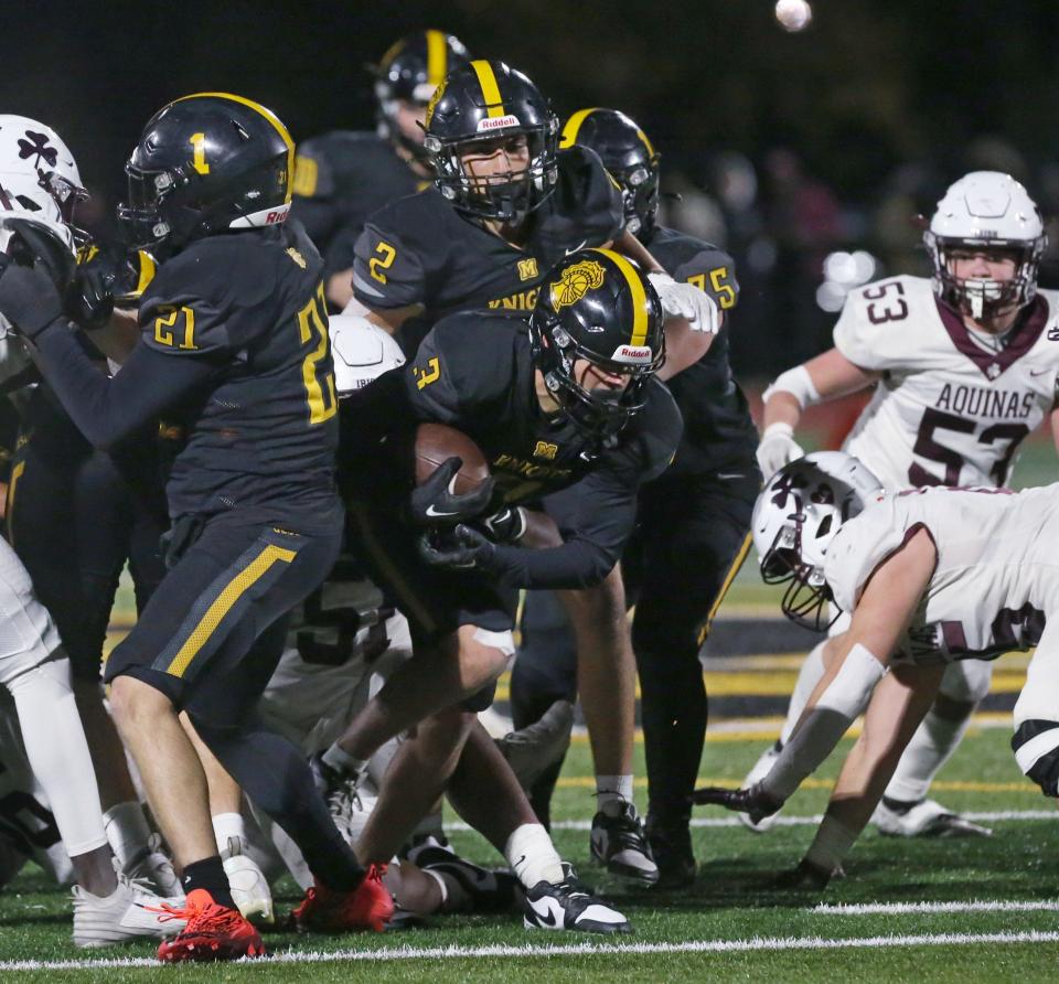 McQuaid running back John Harding pops through the line on his way to the end zone.