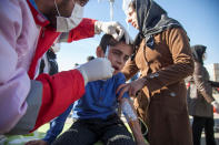 <p>A wounded boy is treated following an earthquake in Sarpol-e Zahab county in Kermanshah, Iran on Nov. 13, 2017. (Photo: Tasnim News Agency/Reuters) </p>