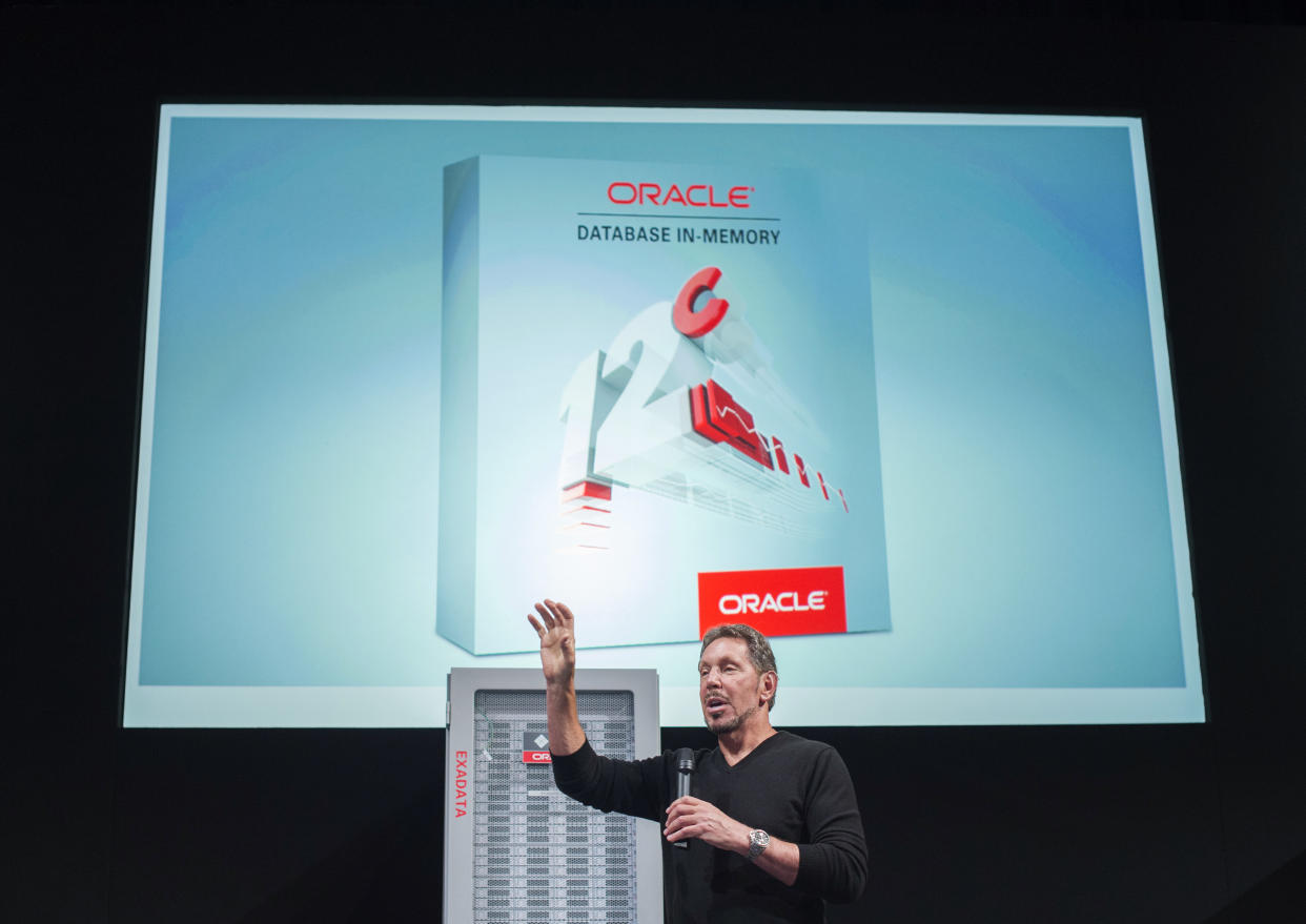 Oracle Corp Chief Executive Larry Ellison onstage in plain black sweater with a screen behind him reading: Oracle Database In-Memory.