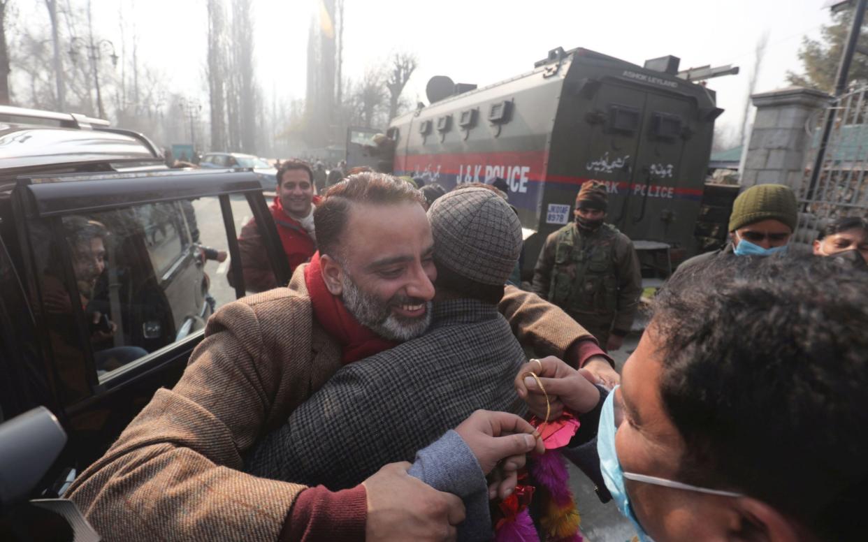 A candidate embraces supporters outside a polling place - FAROOQ KHAN/EPA-EFE/Shutterstock 