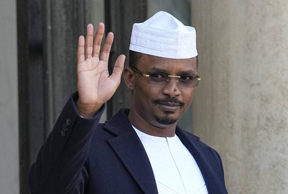 FILE - Chad's Gen. Mahamat Idriss Deby, the head of its military government, waves as he is welcomed by French President Emmanuel Macron for a meeting at the Elysee Palace in Paris, Nov. 12, 2021. Chadian security forces opened fire on anti-government demonstrators in the country's two largest cities Thursday, Oct. 20, 2022 killing at least 60 people, the government spokesman and a morgue official said. Authorities imposed a curfew after the violence, which came amid demonstrations in the central African nation against interim leader Mahamat Idriss Deby's two-year extension of power. (AP Photo/Michel Euler, File)