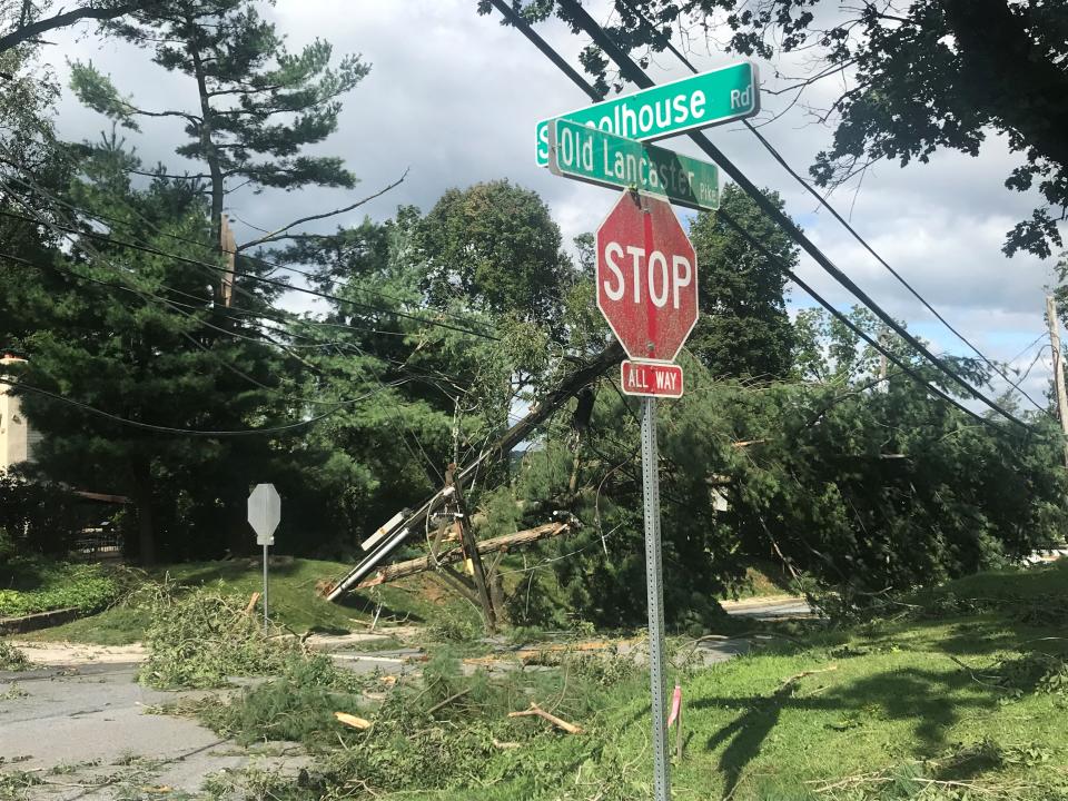 A downed utility pole and a large tree at Schoolhouse Road and Old Lancaster Pike in Hockessin made the roadway impassable on Tuesday morning, Aug, 8, 2023.