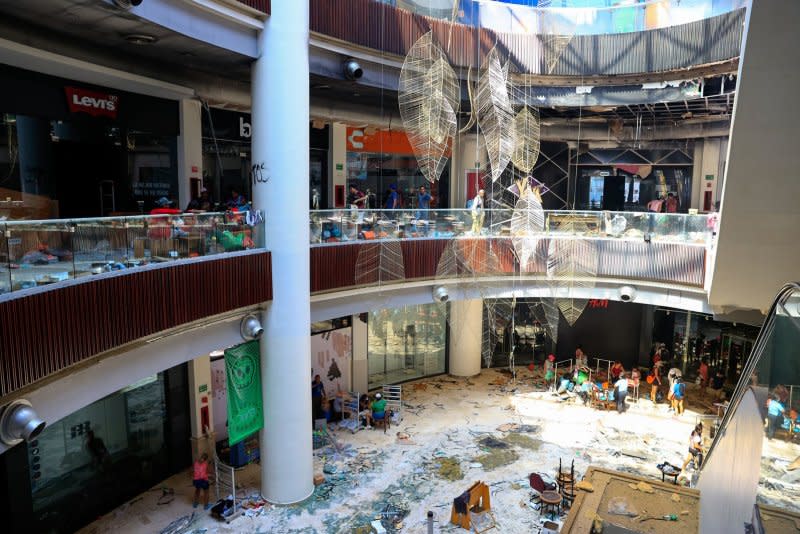 People recover goods from a shopping plaza in an area affected by Hurricane Otis in Acapulco, Mexico on Sunday. Photo by David Guzman/EPA-EFE