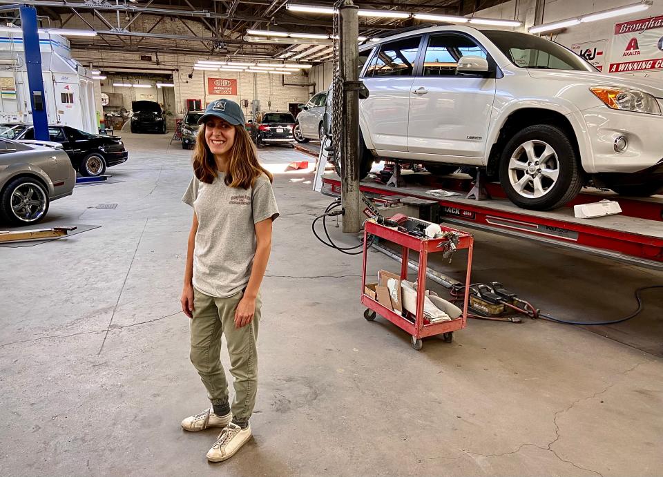 Meredith Ponte stands in the repair shop of her family's Brougham Motors auto body repair business in Fall River.