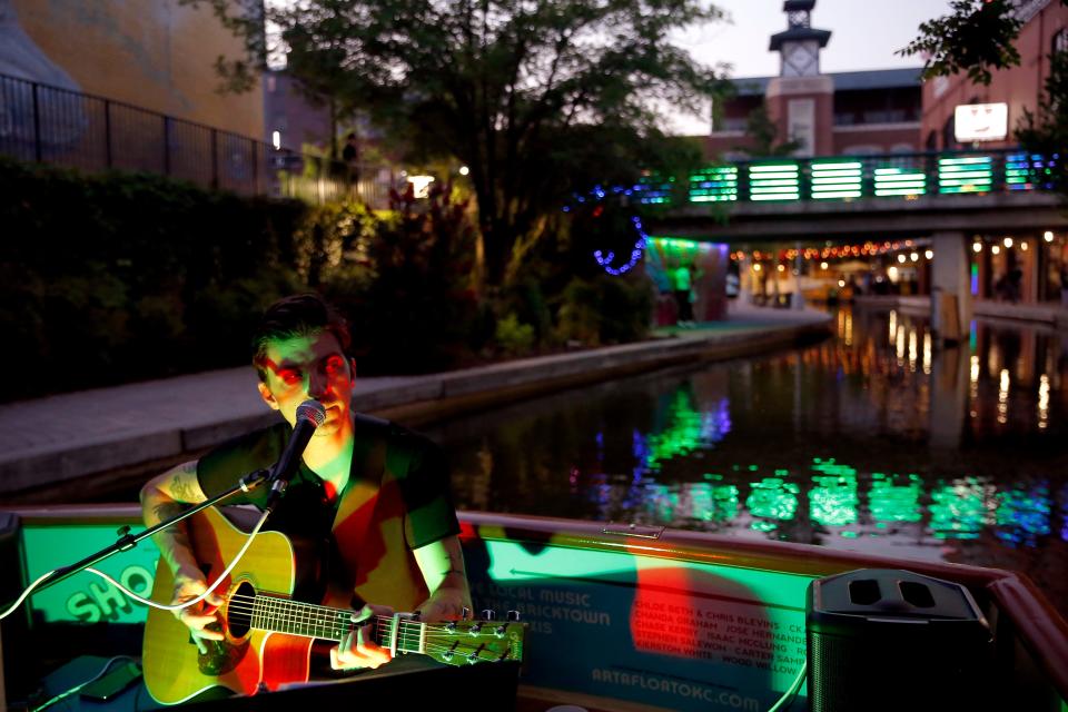 Chase Kerby performs on a Bricktown Water Taxi during a Showboat Concert Series set on the Bricktown Canal in Oklahoma City, Thursday, July 22, 2021. In the series, local musicians perform in concert on one of the boats while cruising the canal.