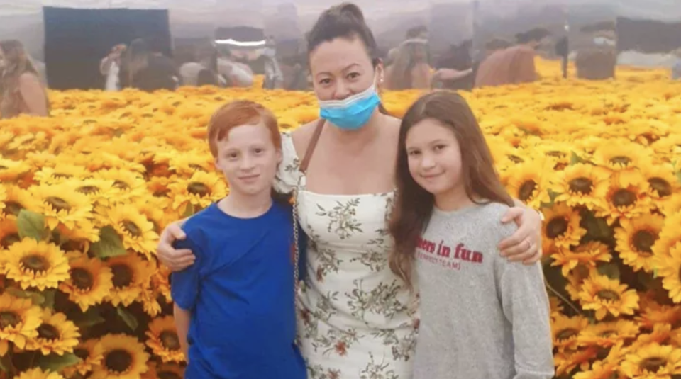 Ms Di Blasio with Lucas Mocanu, 9, his sister Lavinia, 10, in front of sunflowers. 