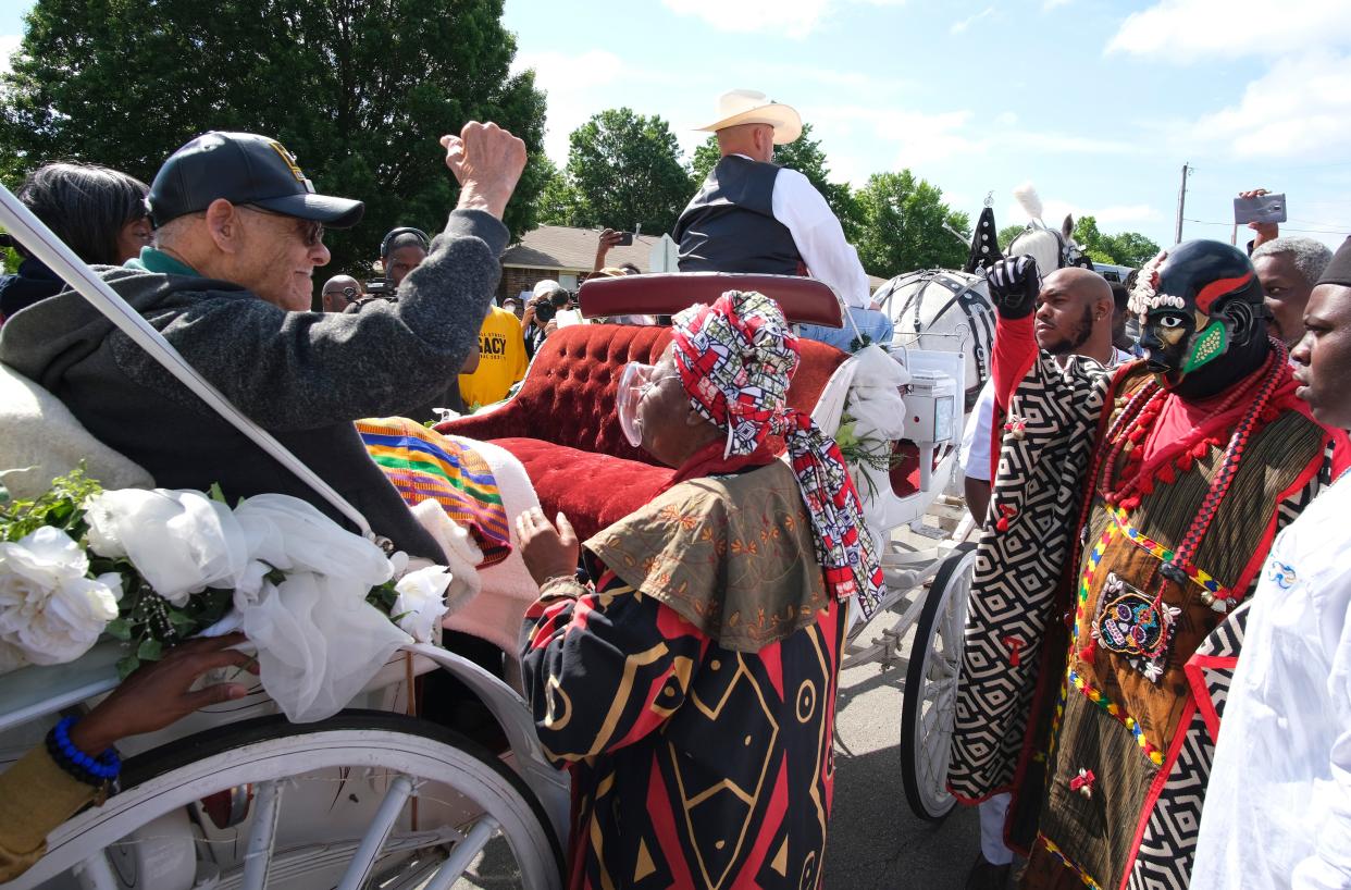 Tulsa Race Massacre survivors, Hughes Van Ellis, Lessie Randle and Viola Fletcher ride in a carriage May 28, 2021, and are greeted by members of the Tulsa African Ancestral Society at the front of the Black Wall St. Memorial March.