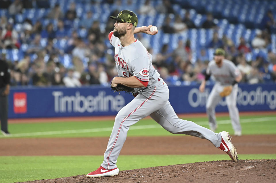 Cincinnati Reds' Hunter Strickland pitches against the Toronto Blue Jays during the seventh inning of a baseball game Friday, May 20, 2022, in Toronto. (Jon Blacker/The Canadian Press via AP)