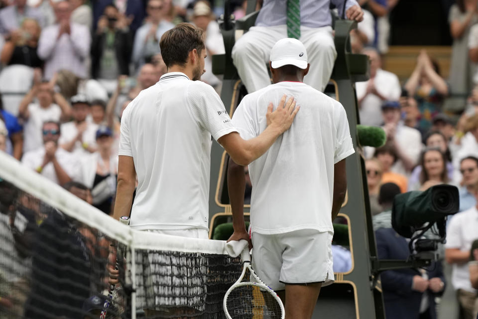 Russia's Daniil Medvedev, left, shakes hands with Christopher Eubanks of the US after beating him in their men's singles match on day ten of the Wimbledon tennis championships in London, Wednesday, July 12, 2023. (AP Photo/Alastair Grant)