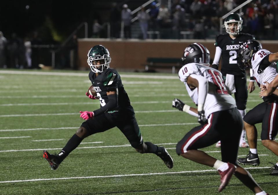 Trinity’s Jeremiah Lynn runs for a first down against Ballard’s Montel Campbell.Oct. 7, 2022