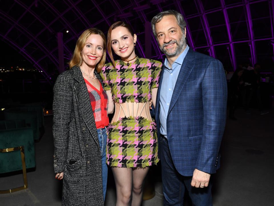 Leslie Mann and Judd Apatow standing between Maude Apatow