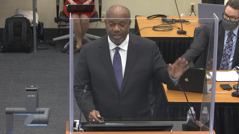 In this image from video, prosecutor Jerry Blackwell, left, speaks while defense attorney Eric Nelson, right, listens, as Hennepin County Judge Peter Cahill presides during opening statements, Monday, March 29, 2021, in the trial of former Minneapolis police officer Derek Chauvin, in the May 25, 2020, death of George Floyd at the Hennepin County Courthouse in Minneapolis, Minn. (Court TV via AP, Pool)