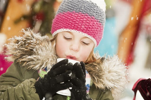 Austria, Salzburg, Girl with cup at christmas market