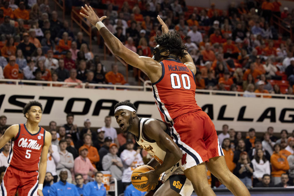 Mississippi's Jayveous McKinnis (00) jumps over Oklahoma State's Moussa Cisse, center bottom, in the first half of an NCAA college basketball game in Stillwater, Okla., Saturday, Jan. 28, 2023. (AP Photo/Mitch Alcala)