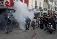 Demonstrators react after police used tear gas during a protest against G7 summit, in Bayonne