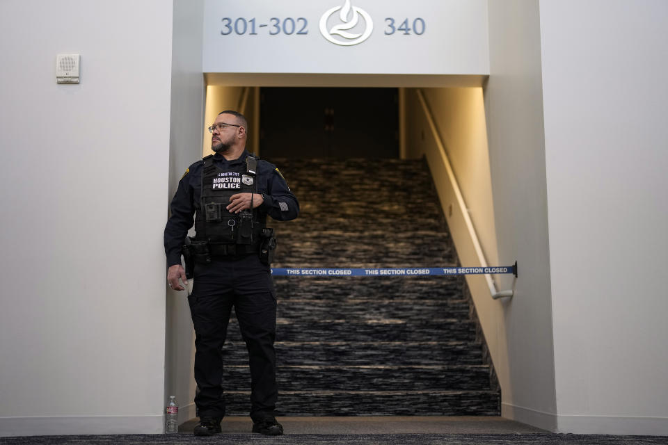 A Houston Police Officer stands at an sanctuary entrance inside Lakewood Church, Sunday, Feb. 18, 2024, in Houston. Pastor Joel Osteen welcomed worshippers back to Lakewood Church Sunday for the first time since a woman with an AR-style opened fire in between services at his Texas megachurch last Sunday. (AP Photo/David J. Phillip)