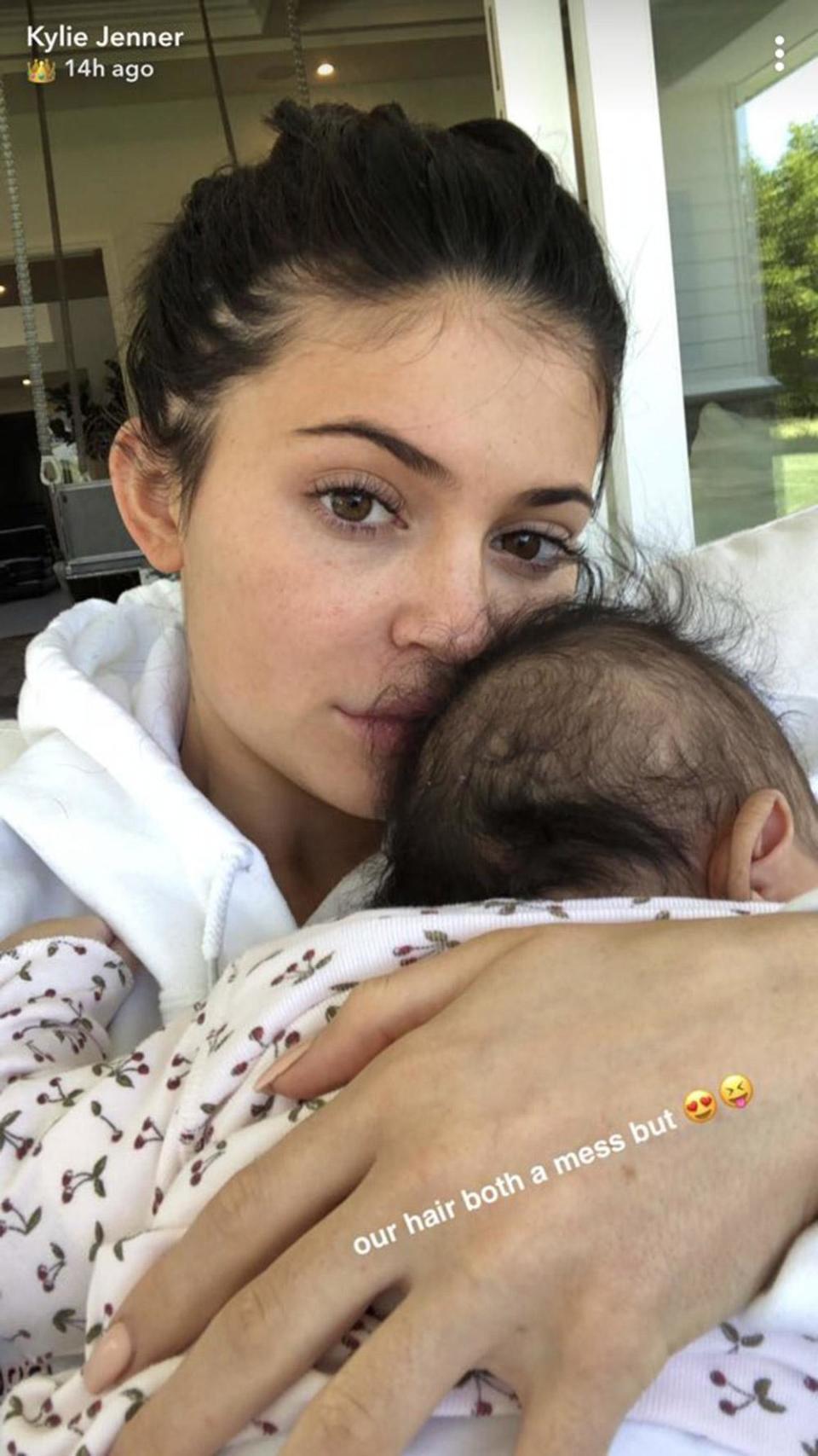 Cuddles: Kylie Jenner snuggled her two-month-old daughter (Snapchat / Kylie Jenner)