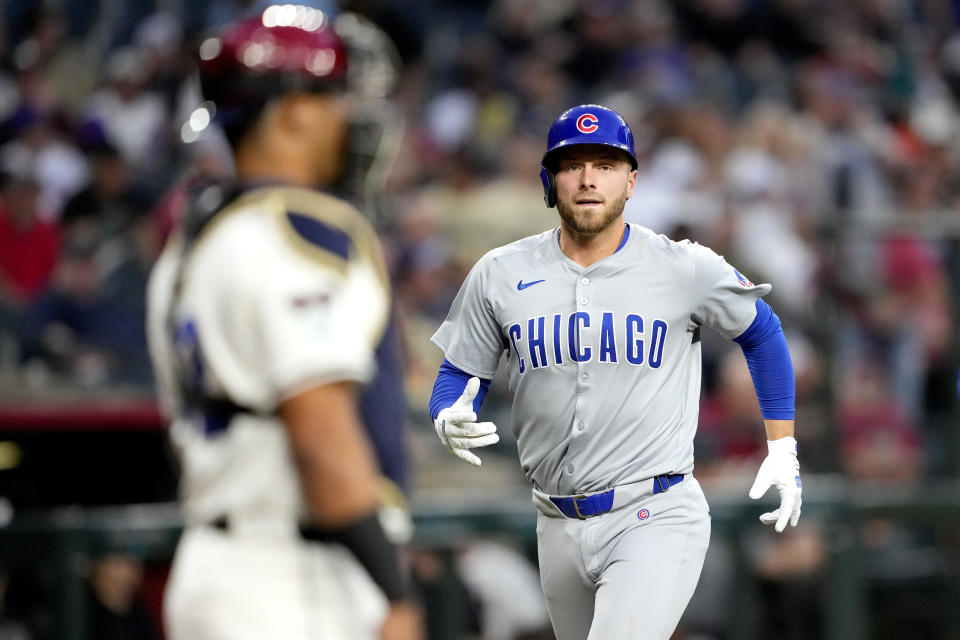 Chicago Cubs' Michael Busch crosses the plate after hitting a solo home run against the Arizona Diamondbacks during the second inning of a baseball game, Monday, April 15, 2024, in Phoenix. (AP Photo/Matt York)