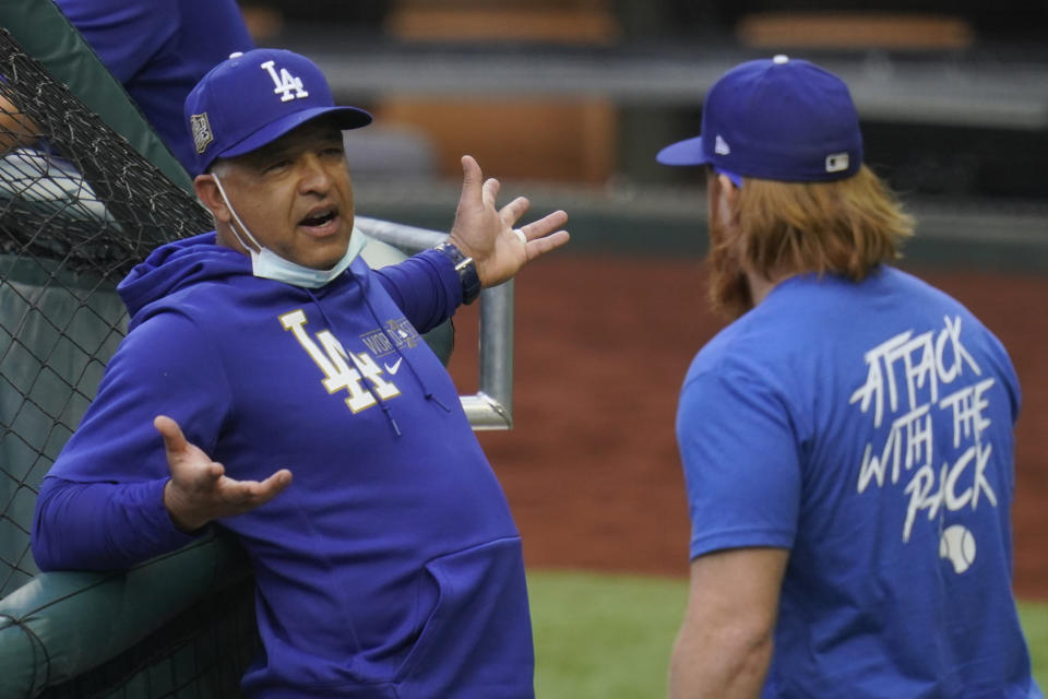 Los Angeles Dodgers manager Dave Roberts talks with third baseman Justin Turner during batting practice before Game 2 of the baseball World Series against the Tampa Bay Rays Wednesday, Oct. 21, 2020, in Arlington, Texas. (AP Photo/Sue Ogrocki)