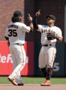 San Francisco Giants shortstop Brandon Crawford (35) and second baseman Donovan Solano celebrate the team's 5-0 victory over the Los Angeles Dodgers in a baseball game Thursday, July 29, 2021, in San Francisco. (AP Photo/Tony Avelar)