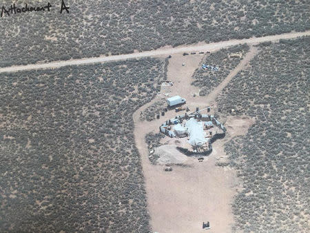 FILE PHOTO: An aerial view of a compound in rural New Mexico where 11 children were taken into protective custody for their own health and safety after a raid by authorities, is shown in this photo near Amalia, New Mexico, U.S., provided August 6, 2018. Taos County Sheriff's Office/Handout via REUTERS/File Photo