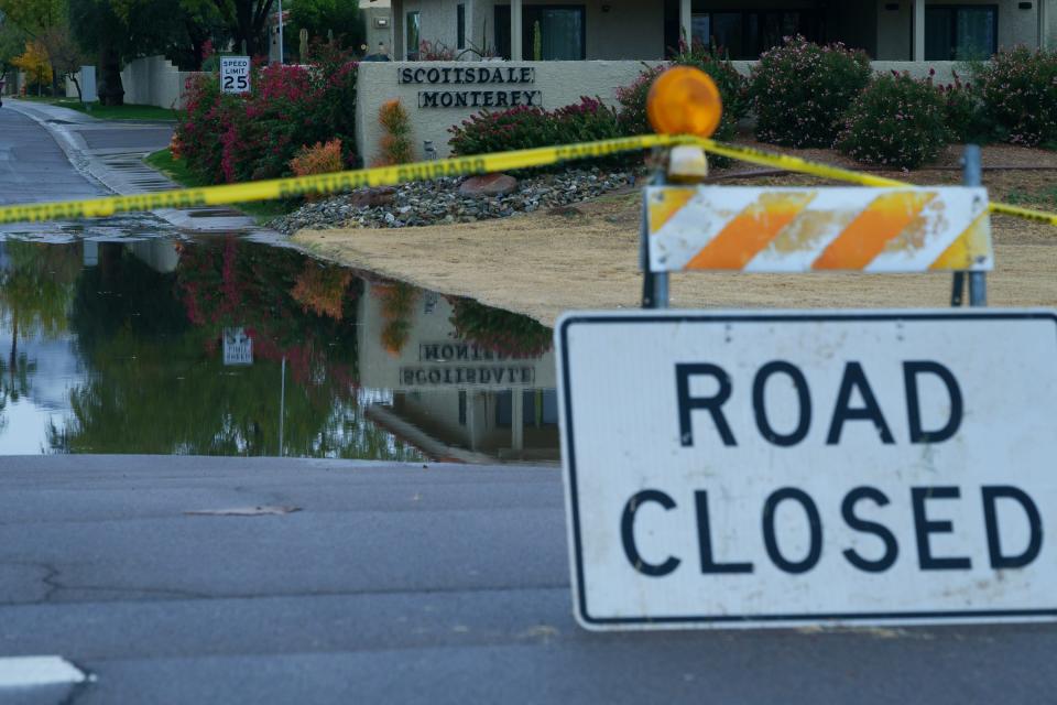 An entrance to a neighborhood near Hayden Road is closed due to flooding during a storm on Dec. 22, 2023, in Scottsdale, Ariz.