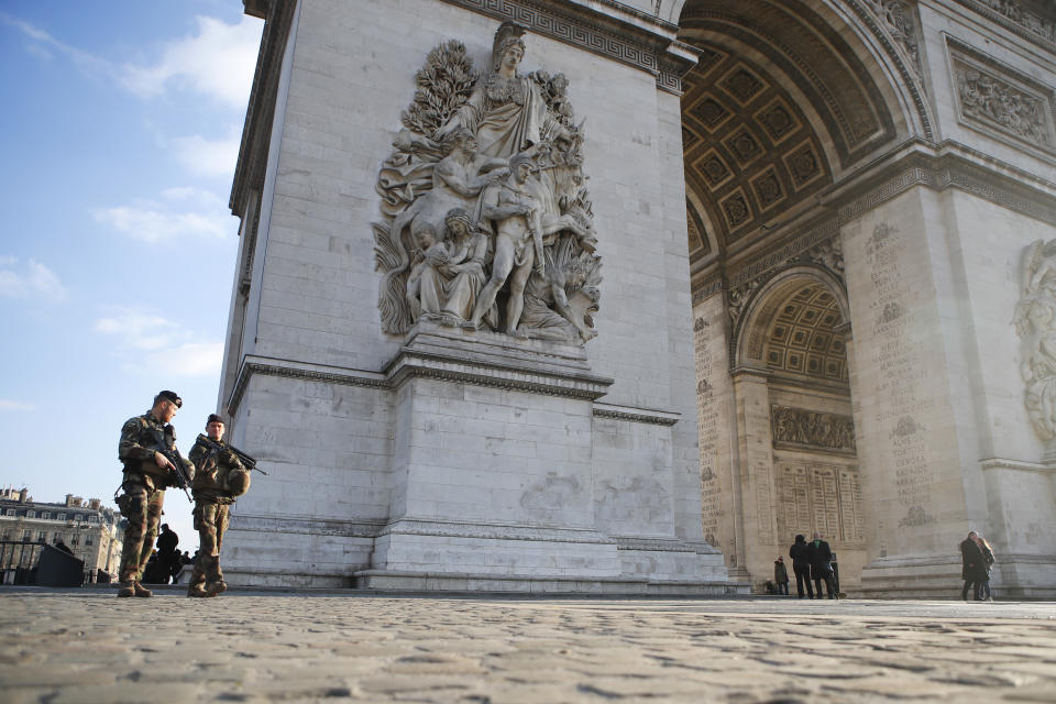 Soldiers patrol by the Arc de Triomphe in Paris, Friday, Dec.14, 2018. Anticipating a fifth straight weekend of violent protests, Paris' police chief said Friday that armored vehicles and thousands of officers will be deployed again in the French capital this weekend. (AP Photo/Francois Mori)