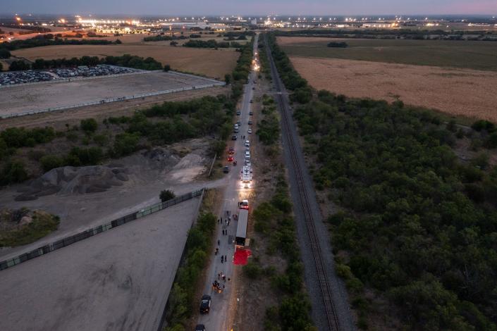 Members of law enforcement investigate a tractor-trailer on June 27, 2022, in San Antonio, Texas. Over a dozen victims were found alive, suffering from heat stroke and taken to local hospitals.