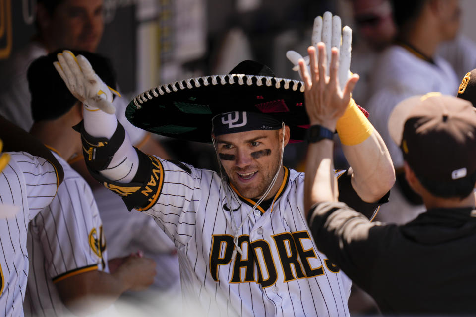 San Diego Padres' Brett Sullivan wears a sombrero as he celebrates with teammates after hitting a two-run home run during the fourth inning of a baseball game against the Cincinnati Reds, Wednesday, May 3, 2023, in San Diego. (AP Photo/Gregory Bull)