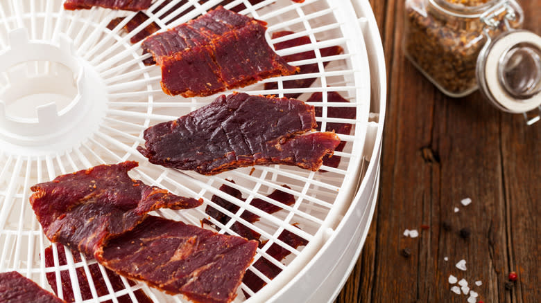 beef jerky loaded onto dehydrator