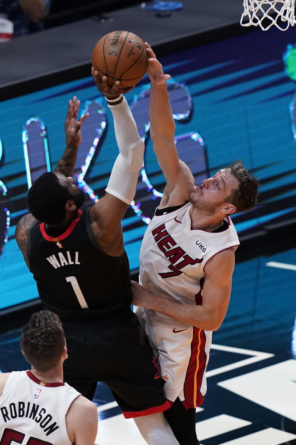 Miami Heat guard Goran Dragic (7) blocks a shot to the basket by Houston Rockets guard John Wall (1), during the second half of an NBA basketball game, Monday, April 19, 2021, in Miami. (AP Photo/Marta Lavandier)