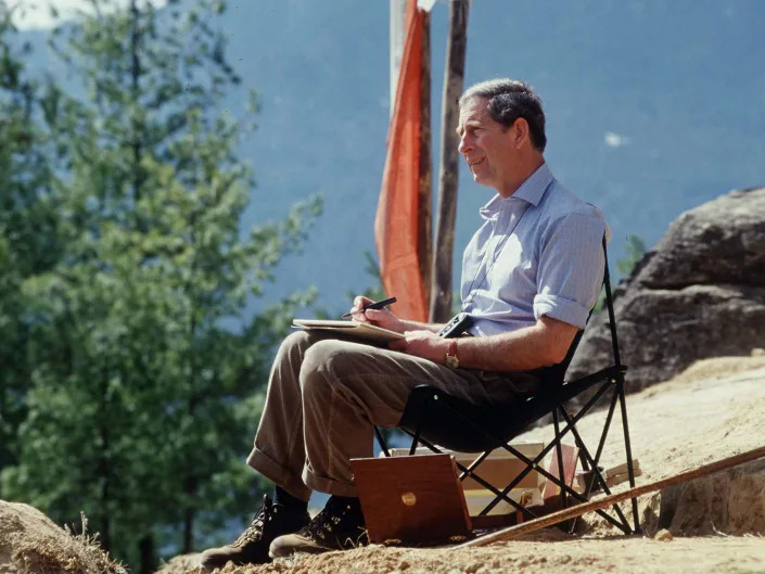 Prince Charles sitting and sketching in Bhutan.