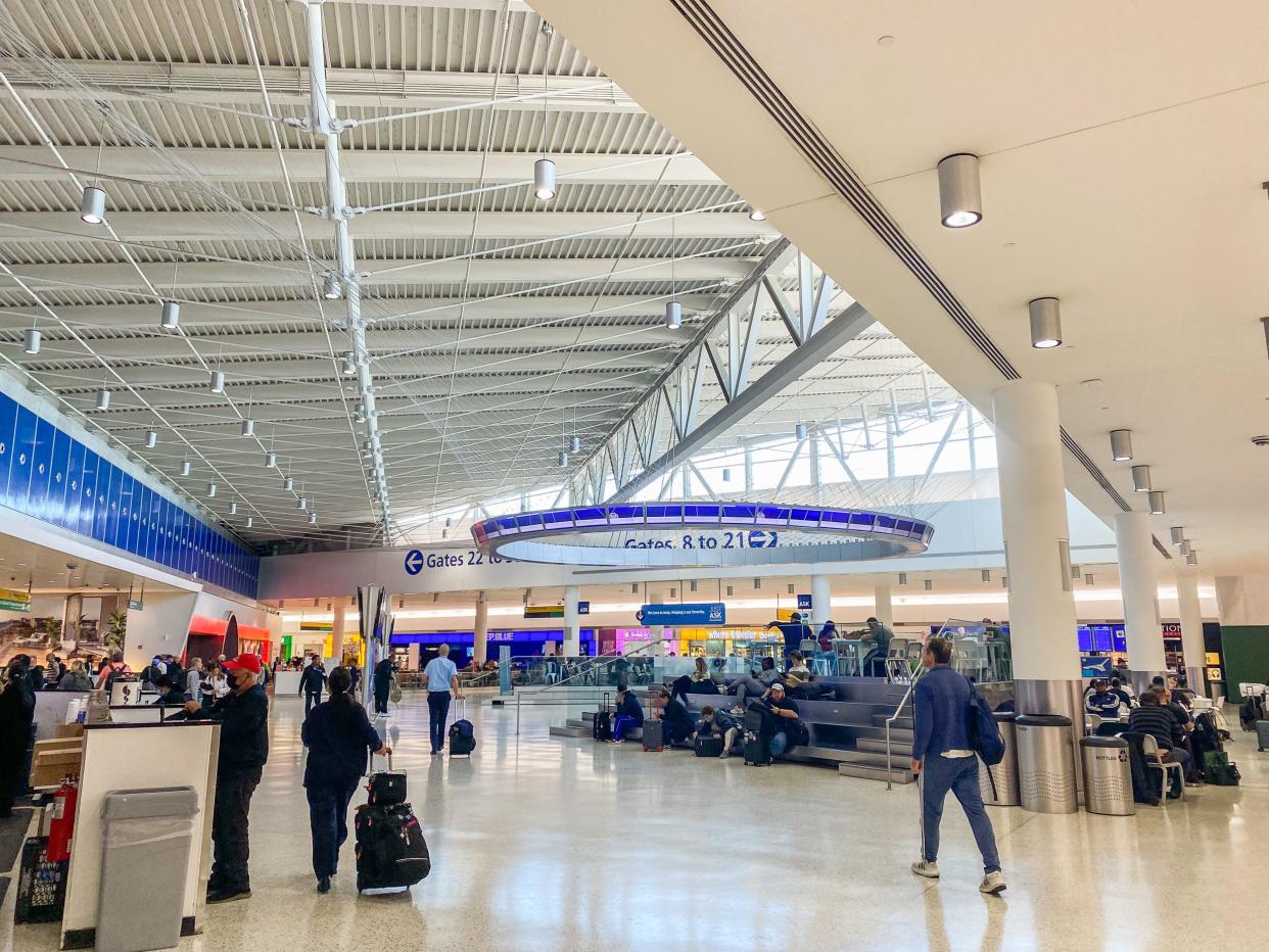 People move through an airport gate