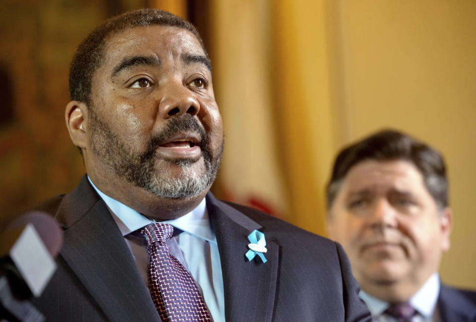 Illinois Department of Children and Family Services Director Marc Smith take questions from reporters during a press conference at the Illinois Capitol in Springfield, Ill., Wednesday, May 15, 2019. Illinois Gov. J.B. Pritzker, right, says the work has begun with a DCFS review of 1,100 cases to ensure that proper steps were taken. The agency's actions have been questioned in the cases of three children under its care who have died since January. (Ted Schurter/The State Journal-Register via AP)