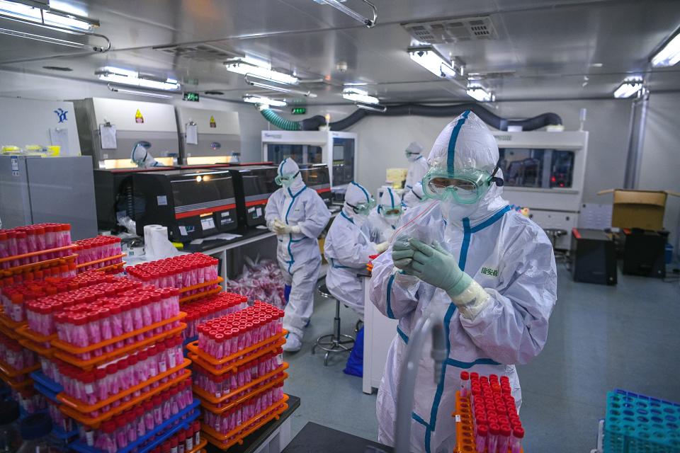 Technicians processing Covid-19 coronavirus tests at a laboratory in Tianjin, China. Source: Getty