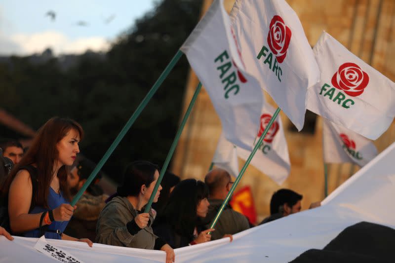 FILE PHOTO: A woman holds a flag of the Revolutionary Alternative Force of the Common (FARC) political party during a protest in support of the Special Jurisdiction for Peace (JEP) in Bogota