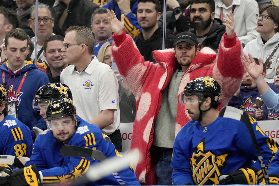 Performer Justin Bieber, center right, dances to the Village People song "Y.M.C.A." during a break in the action during hockey's NHL All-Star Game between Team Matthews and Team McDavid in Toronto, Saturday, Feb. 3, 2024. (Frank Gunn/The Canadian Press via AP)