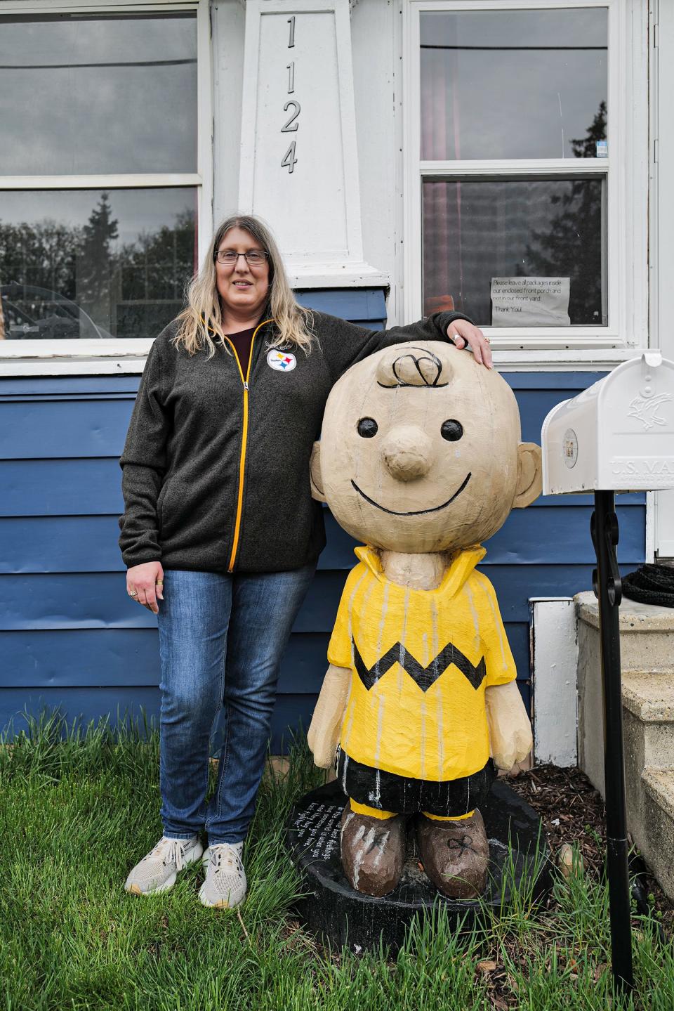 Jennifer Kalacanic from Lansing is selling her heavy, wooden sculpture of Charlie Brown and says she has seen some interest in the piece Thursday, April 20, 2023.