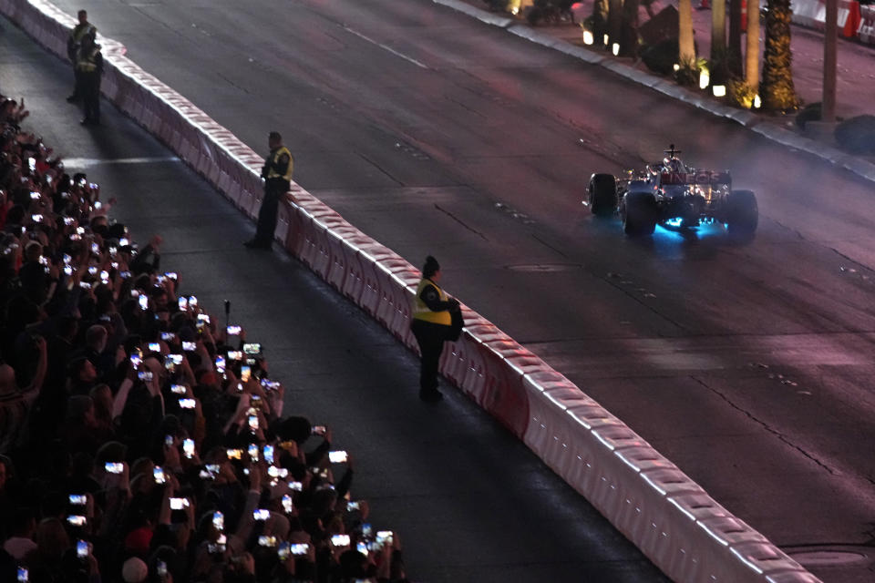 Lewis Hamilton drives during a demonstration along the Las Vegas Strip at a launch party for the Formula One Las Vegas Grand Prix, Saturday, Nov. 5, 2022, in Las Vegas. (AP Photo/John Locher)