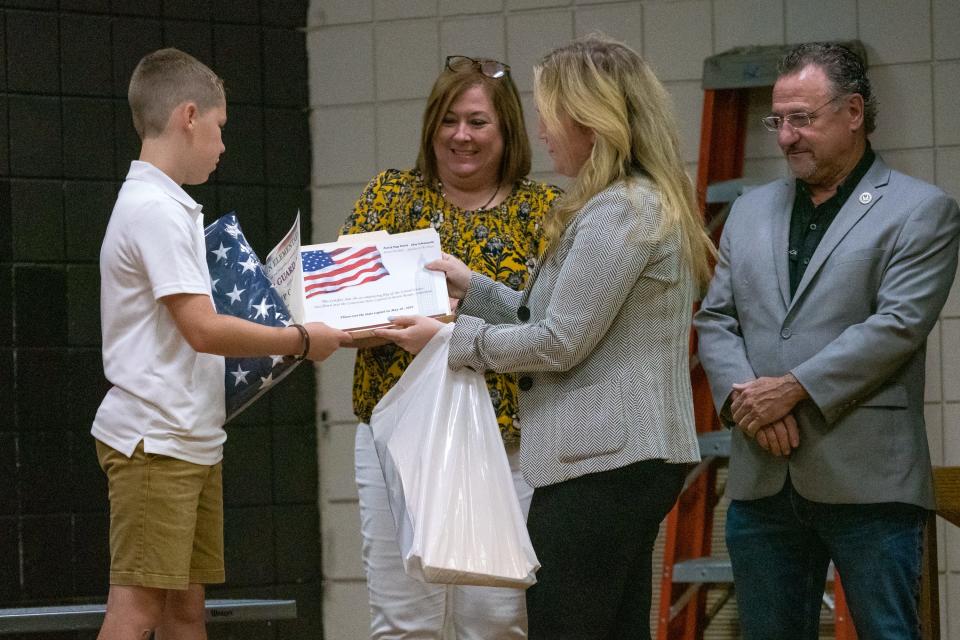 State Reps. Julie Emerson and Jonathan Goudeau award Kip Carter for his commitment as students of Ossun Elementary's color guard group are commended for their service by Lafayette Parish Sheriff Deputies and presented an American flag by state Representatives on Friday, May 20, 2022.
