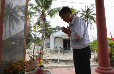 Colonel Vo Cao Tri prays at a monument with a list of names of victims who were killed by US soldiers in the My Lai massacre on March 16, 1968, in his village of My Lai, Vietnam March 14, 2016. Picture taken on March 14, 2018. REUTERS/Kham