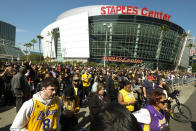 FILE - In this Feb. 24 2020, file photo, fans leave the Staples Center after a public memorial for former Los Angeles Lakers star Kobe Bryant and his daughter, Gianna, in Los Angeles. Staple Center is one of the possible locations the NHL has zeroed in on to host playoff games if it can return amid the coronavirus pandemic. The league will ultimately decide on two or three locations for games, with government regulations, testing and COVID-19 frequency among the factors for the decision that should be coming within the next three to four weeks. (AP Photo/Ringo H.W. Chiu, File)