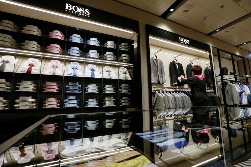 FILE PHOTO: An employee displays clothes in the Hugo Boss section in the Central Universal Department Store in Kiev