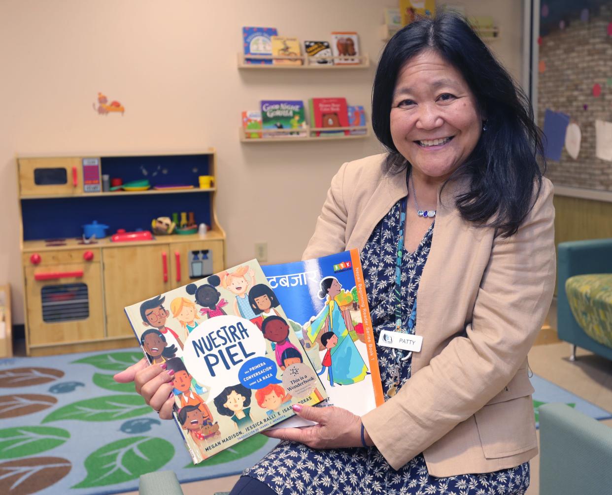 Cuyahoga Falls children's librarian Patty Guinto shows children's talking language books Nov. 14.