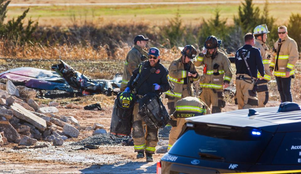 Oklahoma City Fire Department workers process the scene of a plane crash on Dec. 10, 2023, near Wiley Post Airport in Bethany.